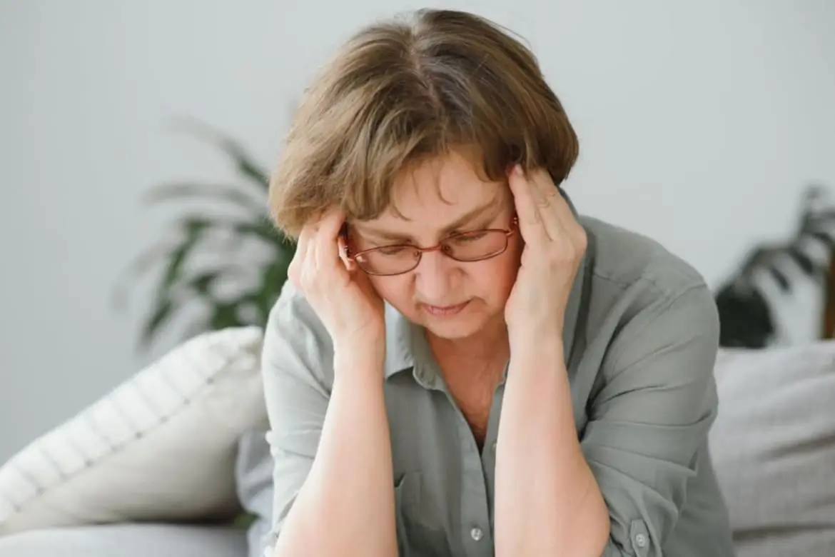 Illustration of a sad woman sitting alone, symbolizing depression symptoms and mental health awareness